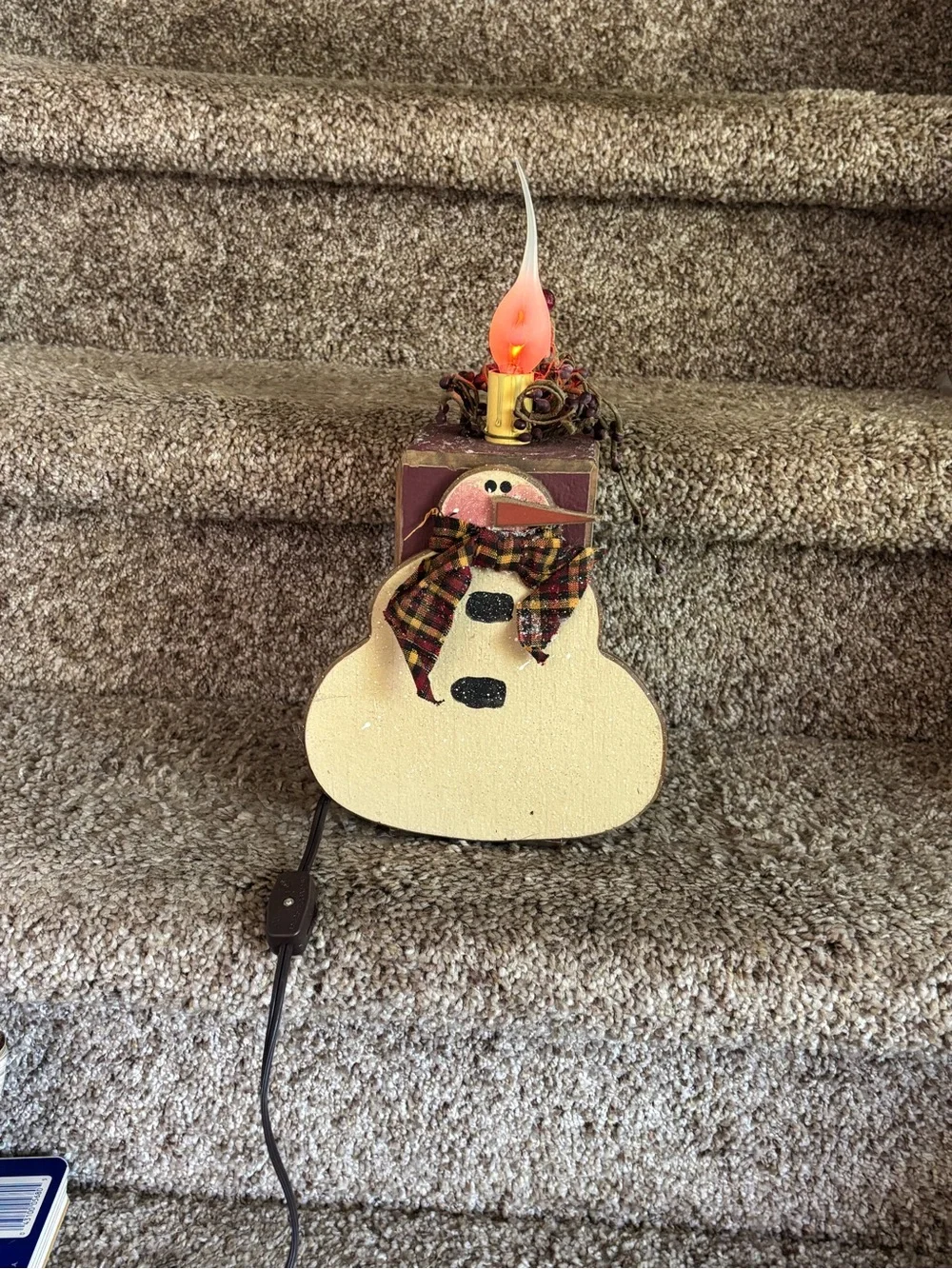 Wooden snowman with electric candle